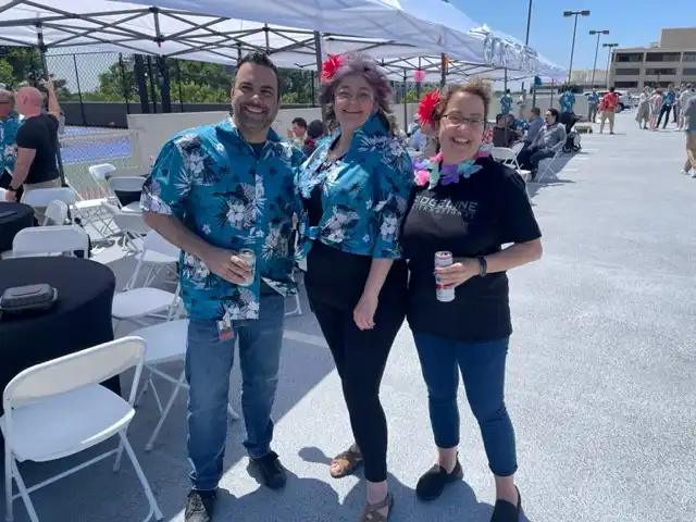 three people celebrating in ridgeline apparel at a party