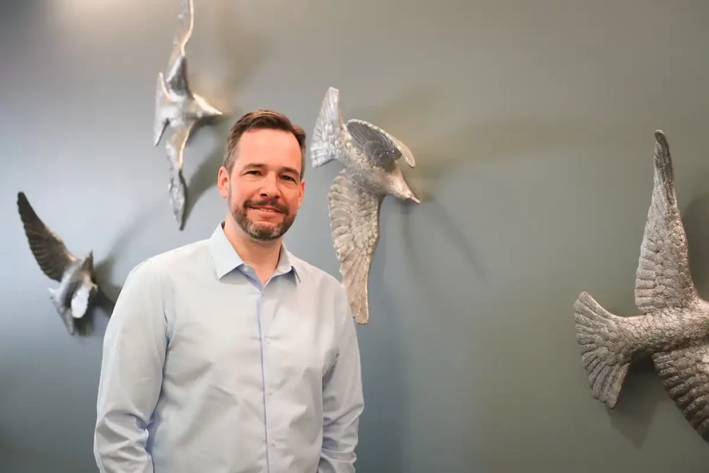 Photo of Tim, a software engineer, posing in Ridgeline's office