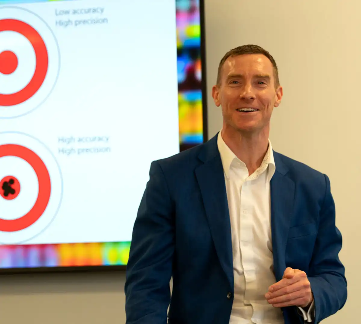 Ridgeline CEO Erik Wittreich in a suit giving a presentation with a big screen behind him